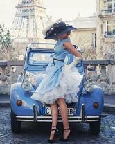 Нарядная девушка возле ретро-авто в Париже